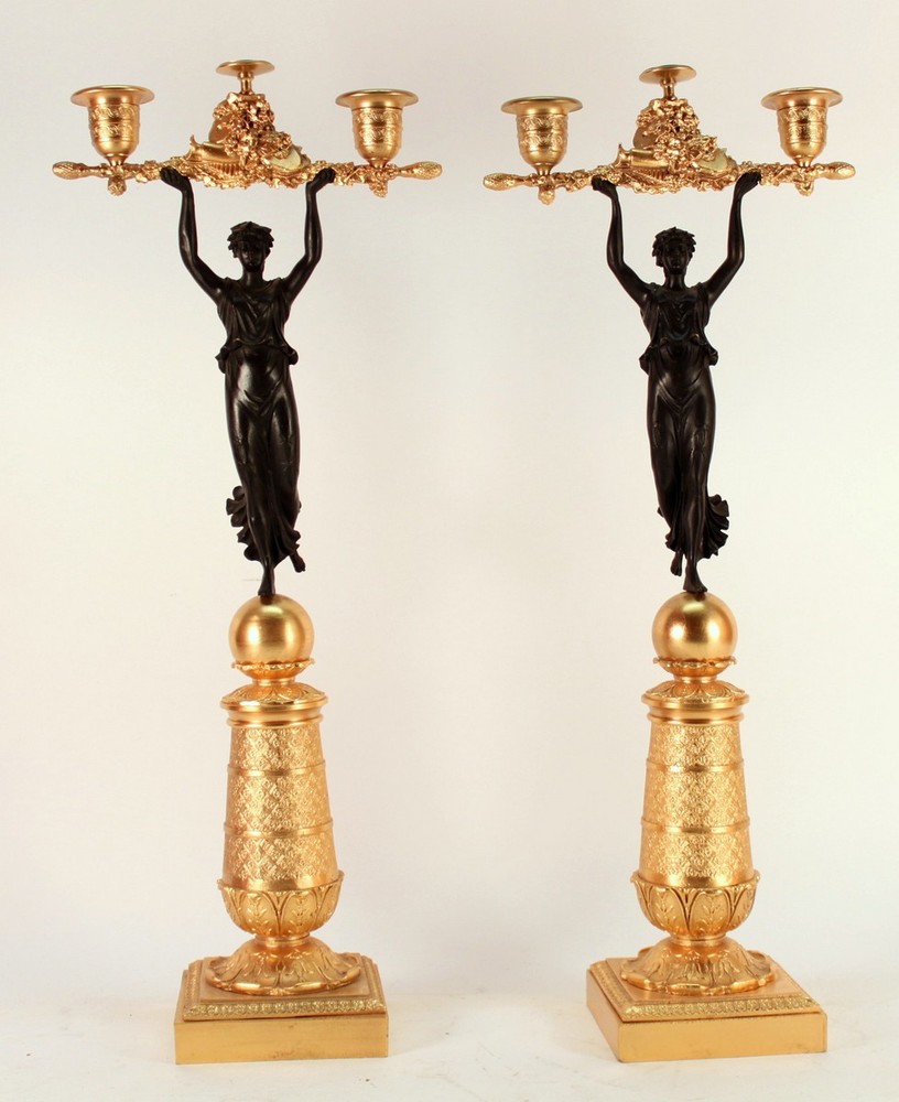 A pair of bronze and gilt candleholders