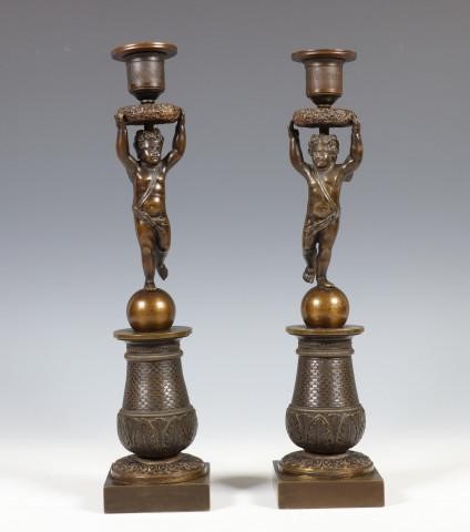 A pair of bronze empire candleholders, putti 