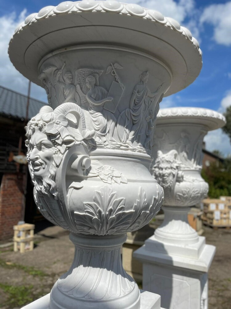 A pair of capital marble vases on stands