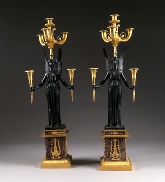 A pair of large bronze candleholders